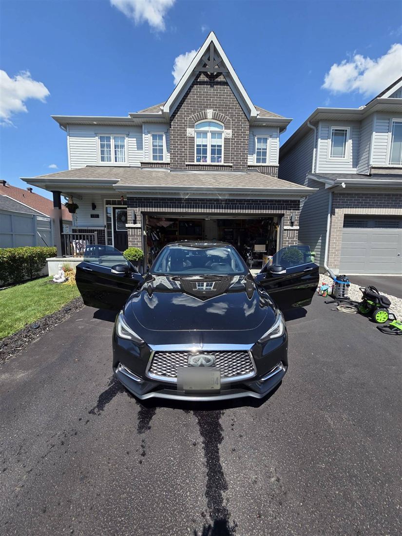 Black Infiniti coupe detailed in a customer's driveway